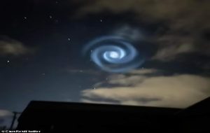 Mysterious glowing swirl lights up the night sky and mesmerises onlookers - but what caused the strange sight?