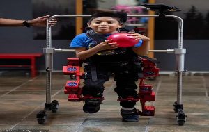 Boy, 8, stricken with cerebral palsy takes his first steps thanks to a new exoskeleton with mechanical joints that adapt to his movements