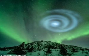 Mysterious blue swirl lights up the night sky over Alaska and mesmerises onlookers - but what caused the strange sight?