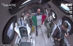 A fist bump for history! Crew onboard Virgin Galactic spaceplane celebrates successful launch by locking knuckles as company's first commercial space mission goes to plan